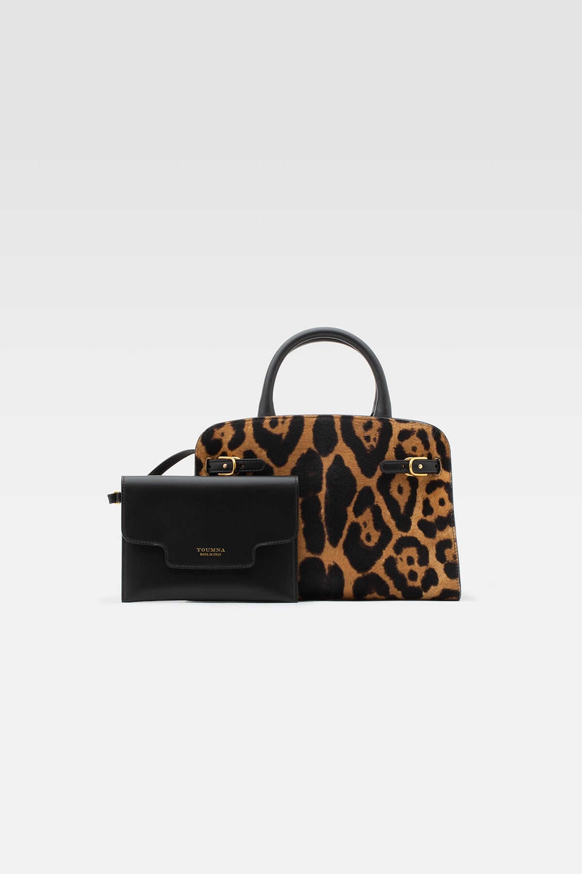 Medium handbag in leo printed leather with pochette in black leather.